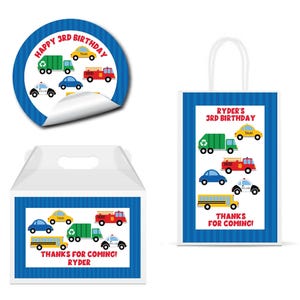 May include: A set of birthday party supplies featuring a blue and white theme with various vehicles. Includes a sticker, gift bag, and favor box. The sticker says "HAPPY 3RD BIRTHDAY". The gift bag and favor box say "THANKS FOR COMING! RYDER".