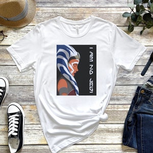 May include: White t-shirt with a graphic of Ahsoka Tano from Star Wars: Rebels. The graphic is a stylized portrait of Ahsoka with the text "I Am No Jedi" in black.