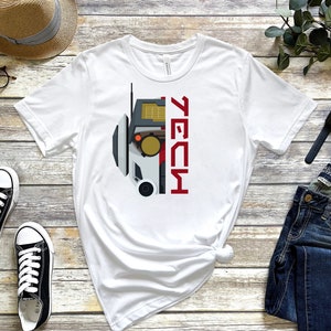 May include: White t-shirt with a graphic of a robot head and the word "TECH" in red lettering.