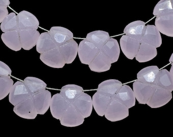 May include: A strand of pale pink gemstone beads, each bead is shaped like a four-leaf clover. The beads are strung on a silver wire.