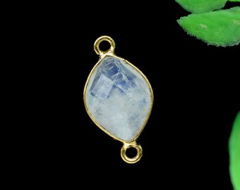 May include: A gold-toned connector with a clear, white moonstone gemstone. The connector has two loops for attaching jewelry.