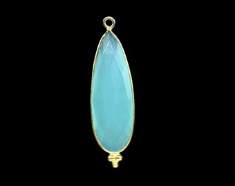 May include: A teardrop-shaped pendant with a light blue gemstone set in gold.