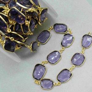 May include: A strand of amethyst gemstone beads connected by gold chain links. The beads are faceted and have a deep purple color. The chain is made of gold-plated metal.