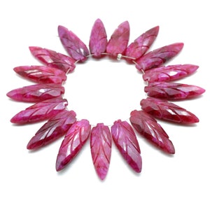 May include: A strand of 18 pink gemstone beads, each carved in the shape of a leaf, strung on a silver wire.
