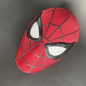 May include: A red Spider-Man mask with a web pattern and black trim around the eyes. The eye openings are white mesh. The mask is a full head covering.