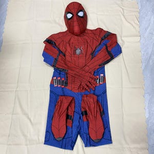 May include: A red and blue Spider-Man costume set, including a mask, jumpsuit, and gloves. The jumpsuit is red with black accents on the arms and a blue lower body. The mask has white eye lenses.