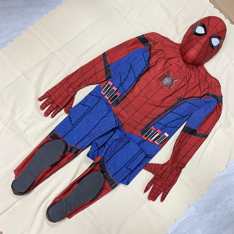 May include: A red and blue Spider-Man costume, including a full-face mask, gloves, and a jumpsuit. The costume features a web pattern on the red areas and blue panels on the torso and legs. The mask has white eye lenses.