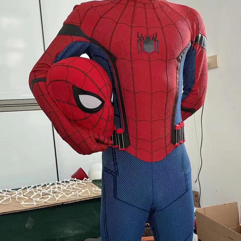 May include: A red and blue Spider-Man costume with a matching mask. The costume features a webbed design on the red areas and a spider emblem on the back. The blue areas have a textured pattern.