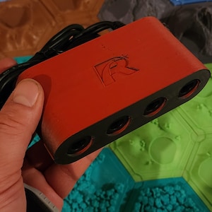 May include: Red and black 4-port USB hub with a black cable and a white 'R' logo.