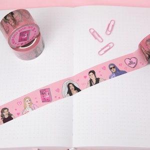May include: Pink washi tape featuring illustrations of characters from the movie Mean Girls. The tape has hearts and the text "So Fetch" on it.