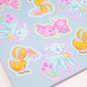 May include: A set of colorful Easter stickers featuring cute cartoon animals like lambs, chicks, and bunnies. The stickers have a pastel color scheme and feature details like flowers, bells, and Easter eggs.