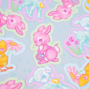May include: A set of pastel-colored Easter stickers featuring a variety of cute animals, including bunnies, lambs, and chicks. The stickers are decorated with flowers, eggs, and other Easter-themed designs.