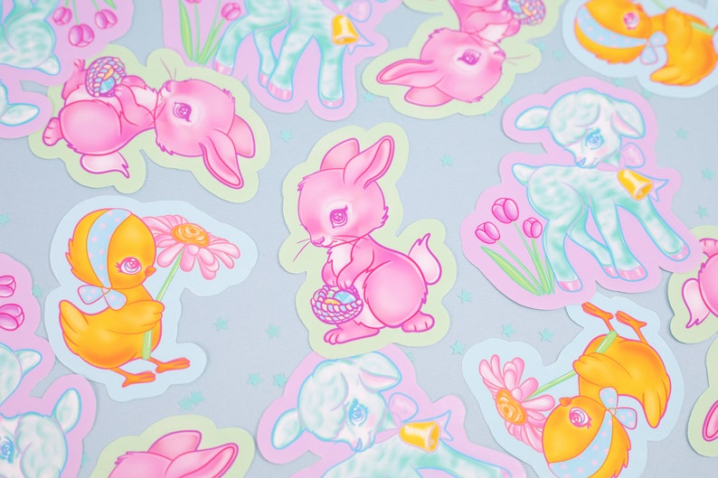 May include: A set of pastel-colored Easter stickers featuring a variety of cute animals, including bunnies, lambs, and chicks. The stickers are decorated with flowers, eggs, and other Easter-themed designs.