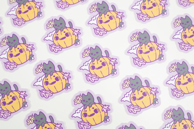 May include: A repeating pattern of stickers featuring a black cat sitting on top of a yellow pumpkin with a white ghost behind it. The stickers are surrounded by purple leaves and are on a white background.