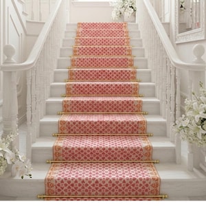 May include: A grand staircase with white balustrades and steps. A patterned red and gold runner covers the center of the steps. White flowers in vases and mirrors adorn the walls, creating an elegant interior design.