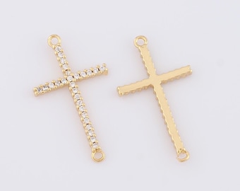 May include: Two gold-tone cross charms with clear rhinestone accents. Each charm has a loop at the top and bottom for attaching to jewelry.
