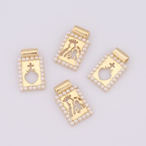 May include: Four gold-toned charms with a pearl border. Each charm features a different religious icon: a heart with a cross, the Holy Family, and two more Holy Family charms.