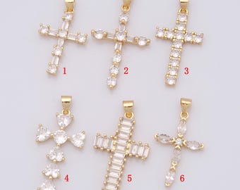May include: Six gold-tone cross pendants with clear crystal embellishments. The crosses are numbered 1 through 6.