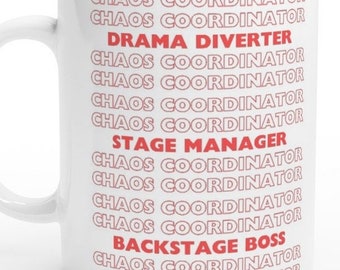 May include: White ceramic mug with the text "CHAOS COORDINATOR" repeated multiple times in pink. The text "DRAMA DIVERTER" and "STAGE MANAGER" are in red. The text "BACKSTAGE BOSS" is in red.