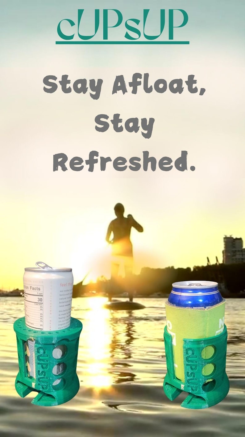 May include: Two green plastic cup holders with the text "cupsup" printed on them. The holders are holding aluminum cans. The cans are on a paddleboard in the water. The background is a sunset.