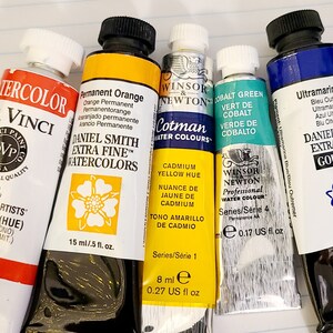 May include: Five tubes of artist's paint, including Daniel Smith Extra Fine Watercolors in Permanent Orange and Ultramarine Blue Gouache, Winsor & Newton Cotman Water Colours in Cadmium Yellow Hue and Cobalt Green, and Da Vinci Professional Quality Watercolor in Permanent Artists' Vermilion (Hue).