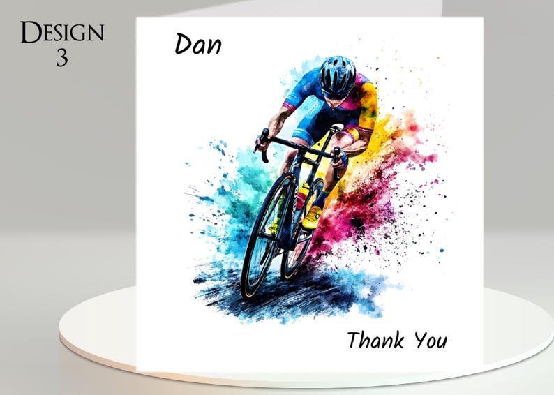 May include: A white greeting card with a watercolor illustration of a cyclist in motion. The cyclist is wearing a blue and yellow uniform and helmet. The card has the text "Design 3", "Dan", and "Thank You".