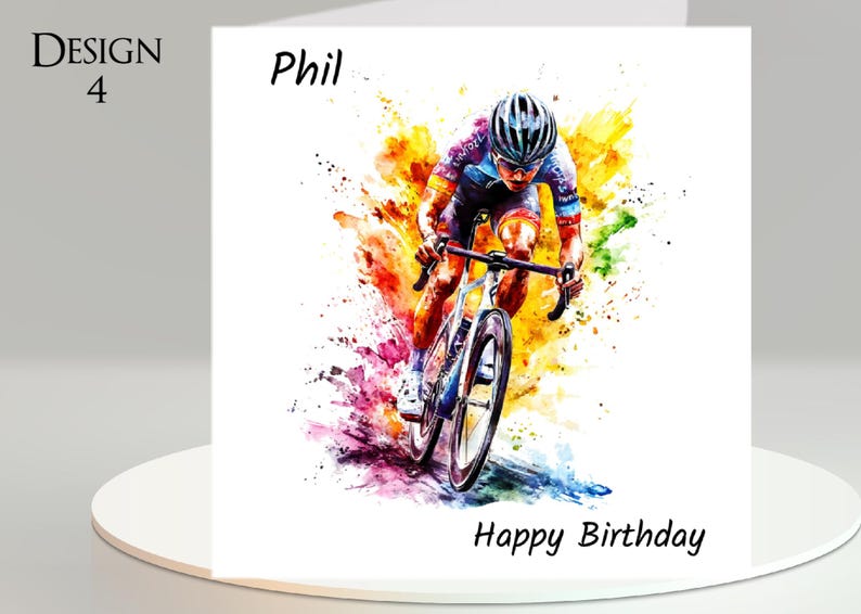 May include: A white greeting card with a watercolor painting of a cyclist in action. The cyclist is wearing a helmet and cycling gear. The card has the text "Design 4", "Phil", and "Happy Birthday".