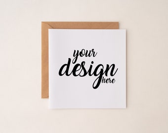May include: A white card with a brown envelope behind it. The card has the text "your design here" written in black cursive.