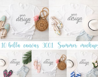 May include: Mockup of a white t-shirt with the text "your design here" on it. The t-shirt is laid flat on a white wooden surface with a straw bag, sandals, and a hat.