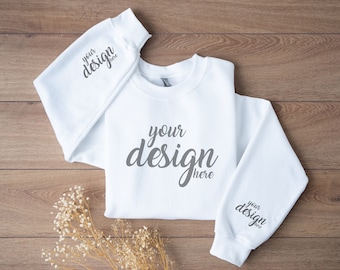 May include: White sweatshirt with long sleeves and a crew neck. The sweatshirt has the text "your design here" printed on the front and both sleeves.