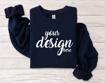 May include: A navy blue sweatshirt with the text "your design here" in white on the front.