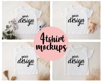 Puede incluir: Cuatro maquetas de camisetas blancas con el texto "your design here" en cada camiseta. Las camisetas están colocadas sobre una superficie de color marrón claro con varios elementos decorativos alrededor.