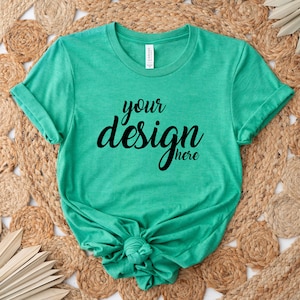 May include: A teal green t-shirt with the text "your design here" printed on the front.