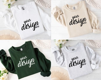 May include: Four sweatshirts in different colors: white, beige, green, and gray. Each sweatshirt has the text "your design here" printed on the front.