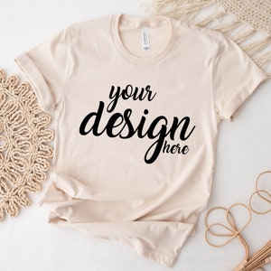 May include: A beige t-shirt with the text "your design here" printed on the front.