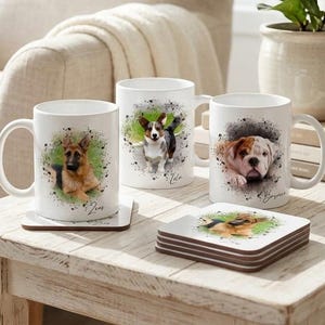 May include: Three white ceramic mugs and a stack of square coasters featuring watercolor-style portraits of a German Shepherd, a Corgi, and a Bulldog. Each mug displays a dog breed with a green and grey paint splatter background and a name.