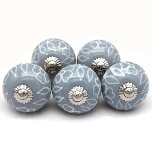 Grey ceramic knob with white hand-painted floral pattern; vintage shabby chic cabinet drawer pull with silver mounting stud.