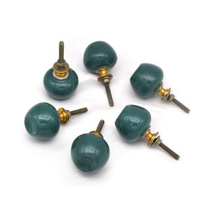 Pair of green ceramic knobs with brass hardware, perfect as drawer knobs or cabinet pulls.