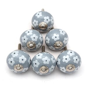 gray ceramic cabinet knobs, hand-painted in white with stripes, dots, flowers, stars, and hearts.