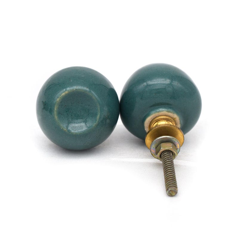 Pair of green ceramic knobs with brass hardware, perfect as drawer knobs or cabinet pulls.