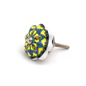 Hand-painted ceramic furniture knob with scalloped edge, yellow and blue mandala pattern, metal screw center for drawer pull.