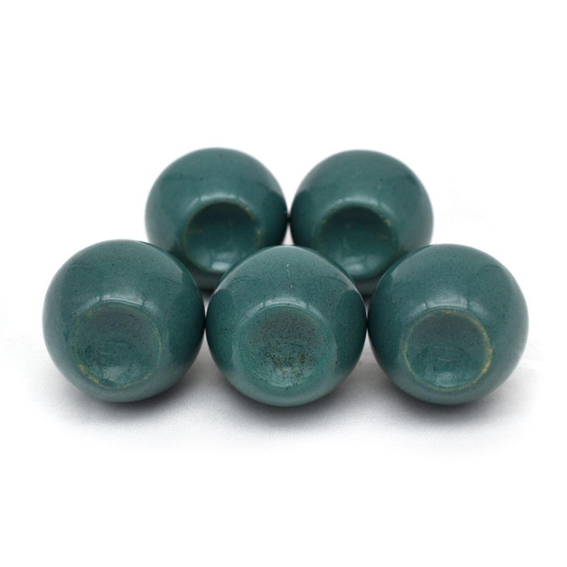Pair of green ceramic knobs with brass hardware, perfect as drawer knobs or cabinet pulls.