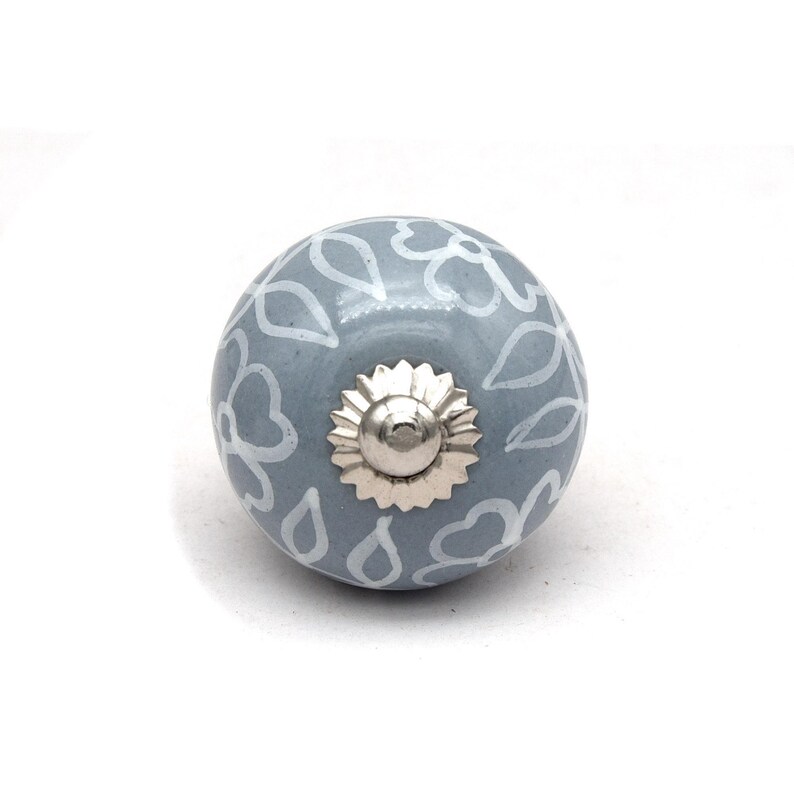 Grey ceramic knob with white hand-painted floral pattern; vintage shabby chic cabinet drawer pull with silver mounting stud.
