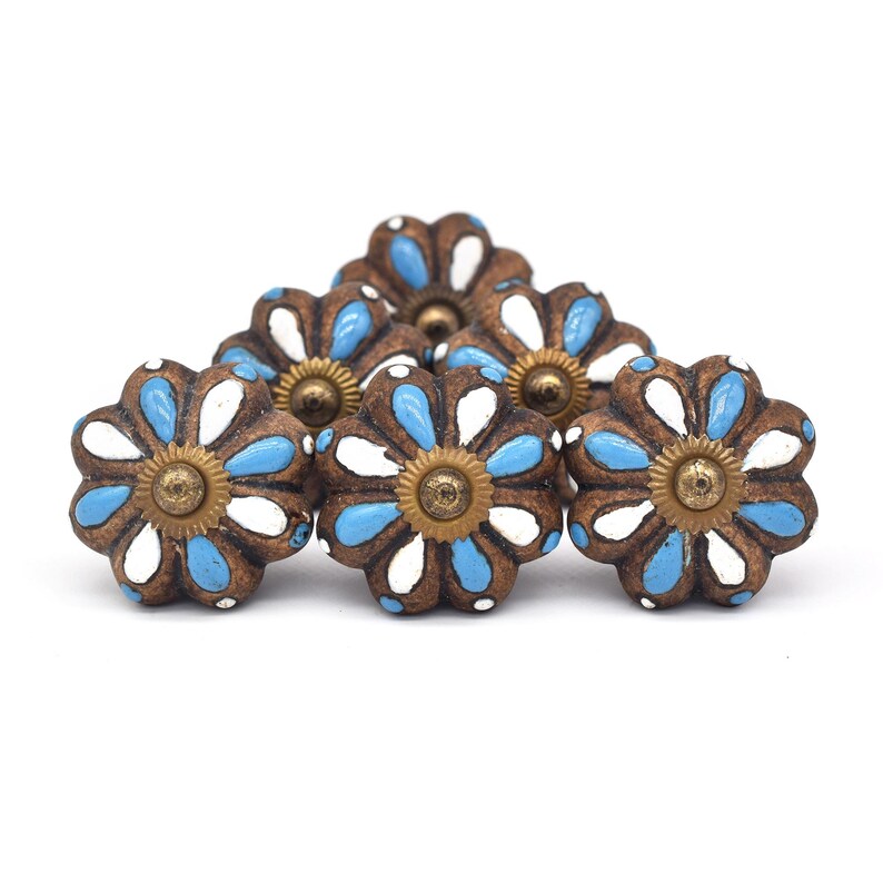 Hand-painted ceramic pumpkin knobs with colorful floral mandala designs in blue, white, red and yellow for cabinets.