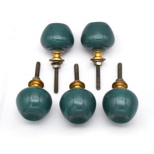 Pair of green ceramic knobs with brass hardware, perfect as drawer knobs or cabinet pulls.