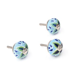 Assorted hand-painted ceramic knobs with blue and turquoise floral motifs for kitchen décor and knob cupboards.
