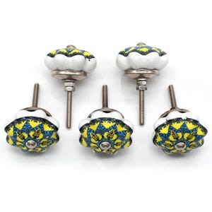 Hand-painted ceramic furniture knob with scalloped edge, yellow and blue mandala pattern, metal screw center for drawer pull.