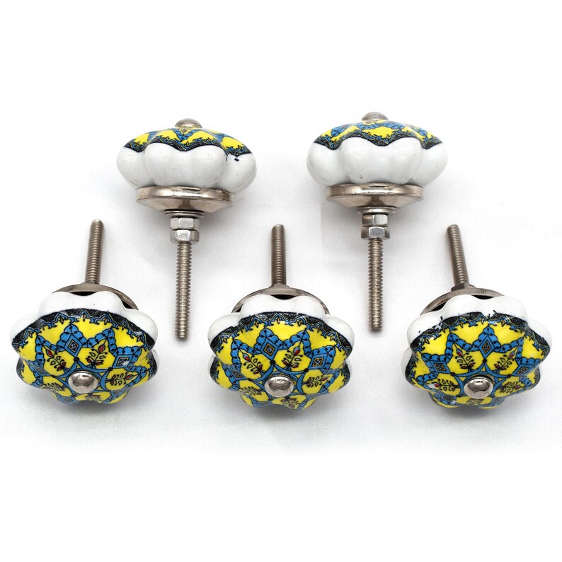 Hand-painted ceramic furniture knob with scalloped edge, yellow and blue mandala pattern, metal screw center for drawer pull.