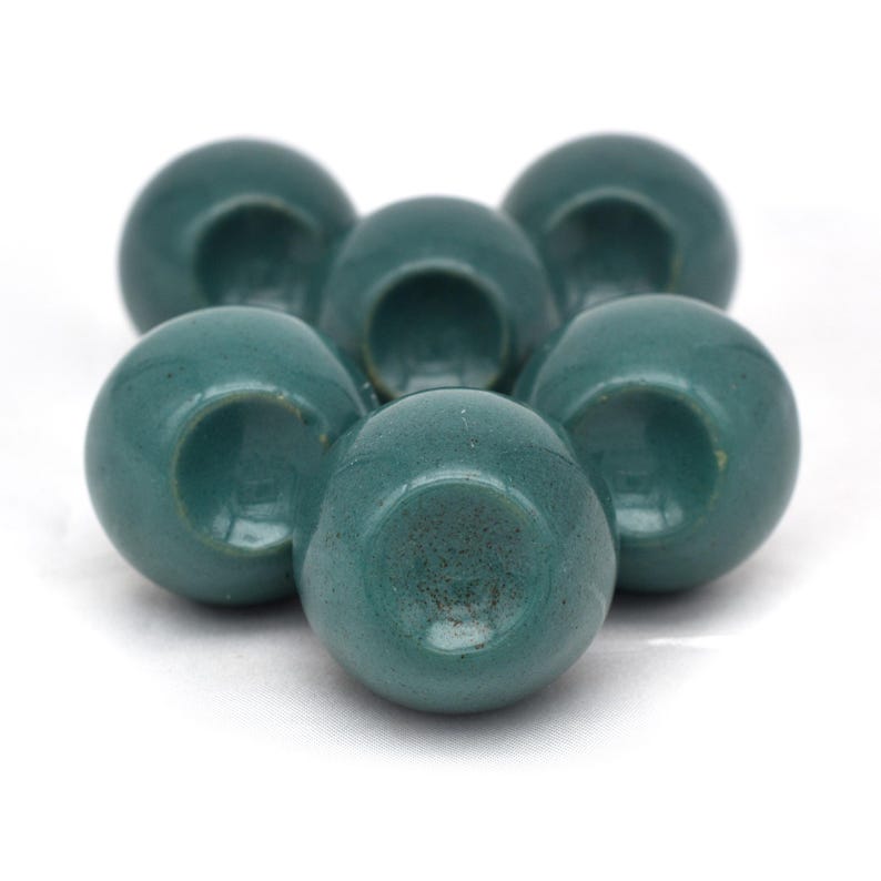 Pair of green ceramic knobs with brass hardware, perfect as drawer knobs or cabinet pulls.