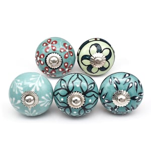 May include: Set of five ceramic knobs with a teal blue base and various floral and geometric patterns in white, black, and red.